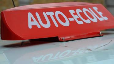 Photo prise le 19 mars 2012 du panneau Auto-Ecole sur le toit d'une voiture au Mans. [Jean-Francois Monier / AFP/Archives]