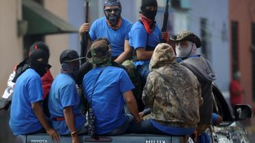 Les forces paramilitaires loyales au président Ortega patrouillent dans les rues de Masaya au Nicaragua, reprise la veille aux rebelles, le 18 juillet 2018 [MARVIN RECINOS / AFP]