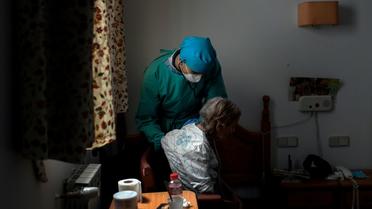 Un médecin examine un résident d'une maison de retraite le 24 avril 2020 à Madrid [OSCAR DEL POZO / AFP]