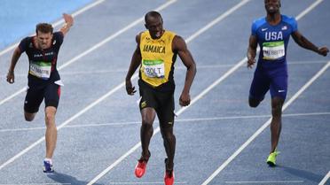 Usain Bolt vainqueur du 200 m et Christophe Lemaitre (g), médaillé de bronze, lors des JO de Rio le 18 août 2016 [PEDRO UGARTE / AFP]