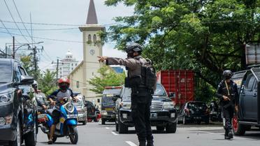 Un policier indonésien régule la circulation après un attentat suicide visant une église, à Makassar, en Indonésie, le 28 mars 2021 [DAENG MANSUR / AFP]
