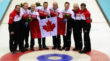 Les champions olympiques canadiens de curling, le 21 février 2014 dans l'Ice Cube de Sotchi [John MacDougall / AFP]