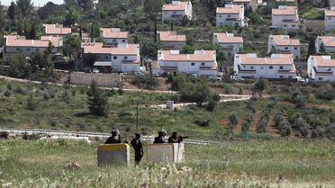 Soldats israéliens en faction après une manifestation hebdomadaire contre l'expansion d'une colonie juive dans le village de Nabi Saleh, en Cisjordanie, le 25 avril 2014 [Abbas Momani / AFP/Archives]