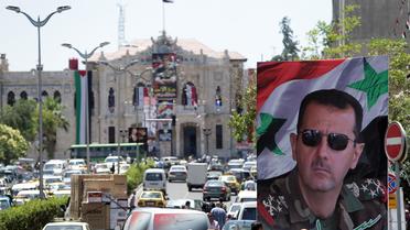 Le portrait du président  Bachar al-Assad le 1er juin 2014 dans une rue de Damas  [Joseph Eid / AFP]