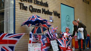 Un admirateur de la famille royale sur un banc devant l'hôpital St Mary, le 19 juillet 2013 à Londres [Ben Stansall / AFP]