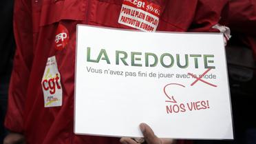 Un employé de La Redoute proteste contre la suppression d'au moins 700 postes, le 21 novembre à Paris [Kenzo Tribouillard / AFP/Archives]