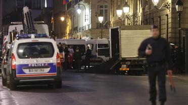 Un policier se tient devant un camion de Greenpeace ayant déversé cinq tonnes de charbon aux portes de l'Elysée, à Paris, le 19 février 2014 [Kenzo Tribouillard / AFP]