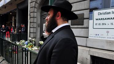 Un Juif devant l'entrée du musée juif de Bruxelles, le 25 mai 2014 où s'amoncellent des gerbes de fleurs, au lendemain de l'attentat qui a fait 3 morts [Georges Gobet  / AFP]