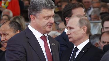 Le président ukrainien Petro Poroshenko et le président russe Vladimir Poutine le 6 juin 2014f Ouistreham [Christophe Ena / Pool/AFP]