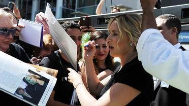 L'actrice Kate Winslet signe des autographes à Hollywood, au moment de dévoiler son étoile sur le Walk of Fame de Los Angeles, le 17 mars 2014 [Robyn Beck / AFP/Archives]