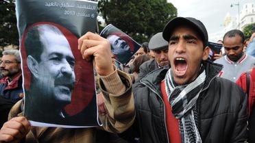 Des portraits de Chokri Belaïd lors d'une manifestation, le 23 février 2013 à Tunis [Fethi Belaid / AFP/Archives]
