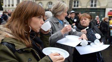 Des personnes "mangent dans le vide" pour défendre les plus démunis, le 21 novembre 2012 devant l'Assemblée nationale à Paris [Miguel Medina / AFP]