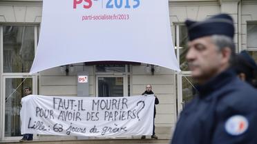Un policier devant le siège du PS lors d'une manifestation en faveur de sans-papiers, le 3 janvier 2013 à Paris [Bertrand Guay / AFP]