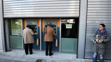 Distributeurs automatiques de la banque chypriote Bank of Cyprus à Athènes, le 22 mars 2013 [Louisa Gouliamaki / AFP]