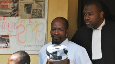 Charles Blé Goudé (C) sort d'un tribunal à Abidjan, le 30 janvier 2013 [Kanga Koffi Firmin Junior / AFP/Archives]