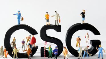 Des figurines posées devant des lettres composant le sigle CSG [Philippe Huguen / AFP/Archives]