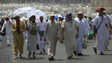 Des pèlerins musulmans marchent dans une rue de la ville sainte de la Mecque en Arabie saoudite avant le début du hajj annuel, le 18 août 2017 [AHMAD AL-RUBAYE / AFP]