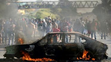 Des manifestants brûlent une voiture sur une route pour dénoncer la hausse des prix du diesel à Ribeirao das Neves au Brésil, le 25 mai 2018 [DOUGLAS MAGNO / AFP]