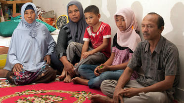 Raudhatul Jannah (deuxième en partant de la gauche) entourée de sa famille après leur réunification, le 7 août 2014.