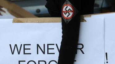Une militante portant une croix gammée barrée sur son bras manifeste le 16 juillet 2012 à Budapest d