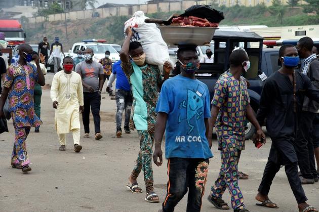 Près d'un poste de contrôle, les passants sont masqués à Lagos, le 4 mai 2020 [PIUS UTOMI EKPEI / AFP]