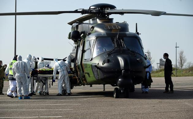 Un malade du Covid-19 est installé dans un hélicoptère militaire français qui va l'évacuer vers l'Allemagne, le 28 mars 2020 à Metz [JEAN-CHRISTOPHE VERHAEGEN / AFP]