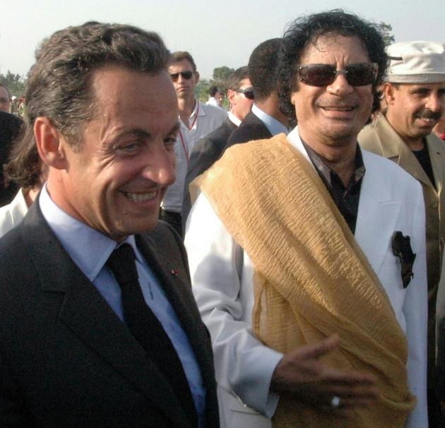 Le président Nicolas Sarkozy (g) est accueilli par le chef libyen  Mouammar Kadhafi (d) à son arrivée à Tripoli, le 25 juillet 2007 [MAHMUD TURKIA / AFP/Archives]