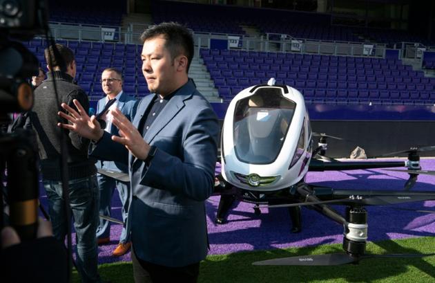 Derrick Xiong (d), responsable marketing de la société EHang, lors de la présentation du taxi-drone à Vienne le 4 avril 2019 [JOE KLAMAR / AFP]