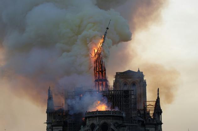 La flèche de Notre-Dame de Paris s'effondre pendant le spectaculaire incendie du 15 avril 2019 [Geoffroy VAN DER HASSELT / AFP/Archives]