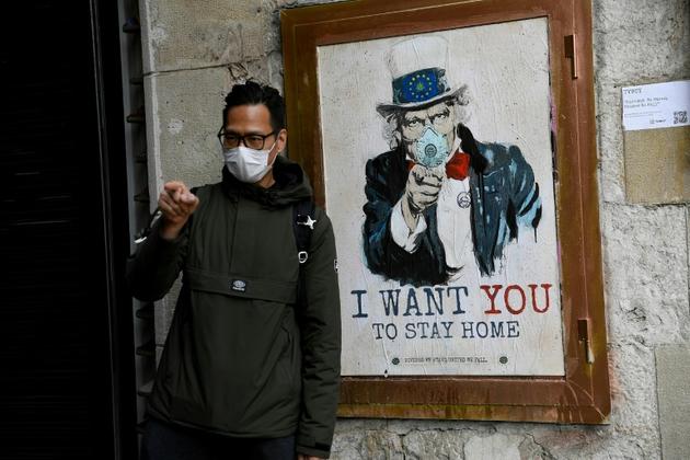 Une affiche de l'artiste TVBoy dans une rue de Barcelone, le 14 mars 2020 [Josep LAGO / AFP]