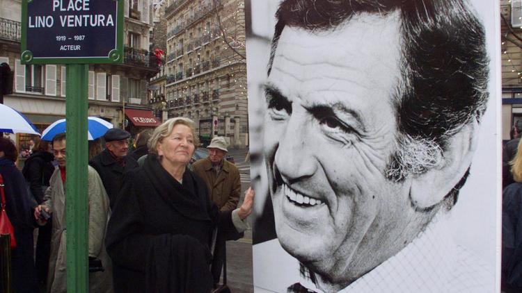 La veuve de l'acteur Lino Ventura, Odette, pose à côté d'une photo de son mari, le 17 décembre 1999  à Paris [Jack Guez / AFP/Archives]