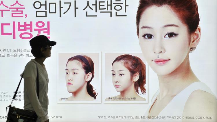 Une affiche pour vanter le recours à une opération esthétique, le 22 mai 2013 dans le métro à Séoul [Jung Yeon-Je / AFP]