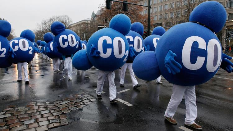 Des membres d'une association déguisés en molécules de CO2 manifestent à Berlin, en décembre 2009 [David Gannon / AFP/Archives]