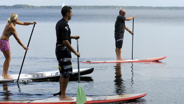 Plus accessible que le surf, le stand up paddle (SUP) a envahi cet été tous les plans d'eau, de l'océan aux rivières en passant par les lacs.[AFP]