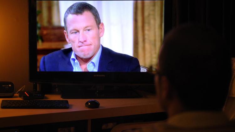 Une personne regarde l'émission d'Oprah Winfrey où Lance Armstrong a avoué s'être dopé, le 17 janvier 2013 [Mandel Ngan / AFP/Archives]