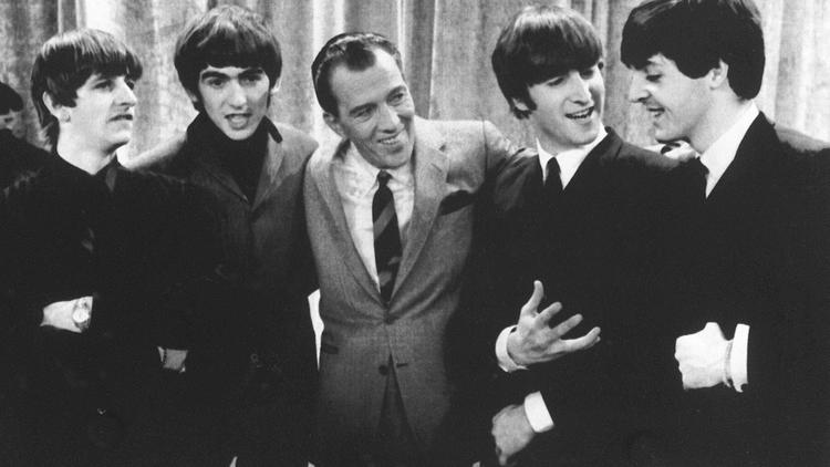 Photo du Groupe Beatles à New York en 1964 lors d'un show télévisé présenté par Ed Sullivan (C). De gauche à droite : Ringo Starr, George Harrison, John Lennon et Paul McCartney.