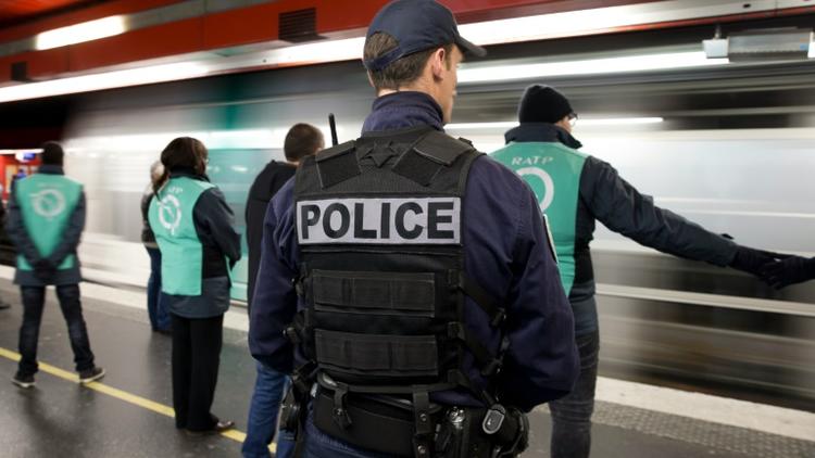 Un policier et des employés de la RATP, le 30 décembre 2015 à Paris [KENZO TRIBOUILLARD / AFP]