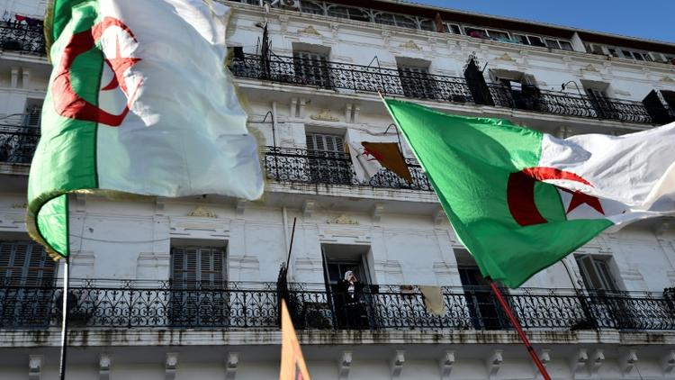 Des drapeaux algériens flottent au vent lors d'un rassemblement contre le pouvoir, le 6 décembre 2019 à Alger [RYAD KRAMDI                         / AFP/Archives]