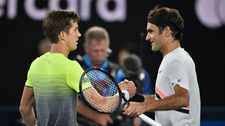 Le Suisse Roger Federer serre la main du Slovène Aljaz Bedene qu'il a battu au 1er tour de l'Open d'Australie le 16 janvier 2018 [PETER PARKS / AFP]