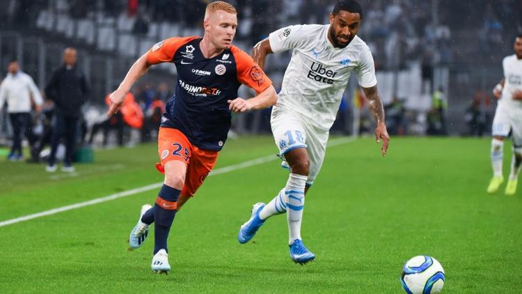 Le milieu de Montpellier Florent Mollet (g) et le défenseur de Marseille Jordan Amavi le 21 septembre 2019 à Marseille  [SYLVAIN THOMAS / AFP]