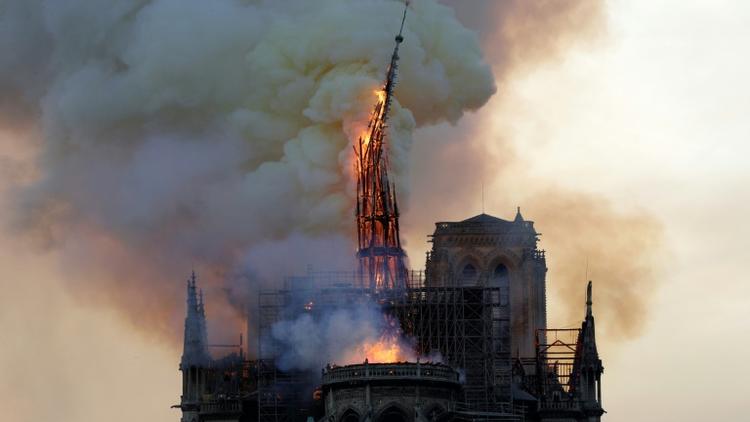 La flèche de Notre-Dame en flammes se brise, le 15 avril 2019 à Paris [Geoffroy VAN DER HASSELT / AFP/Archives]