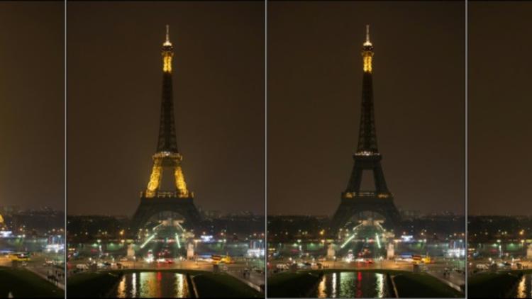 La Tour Eiffel plonge peu à peu dans le noir le 23 mars 2013 à l'occasion de l'"Heure pour la planète" [BERTRAND LANGLOIS / AFP/Archives]