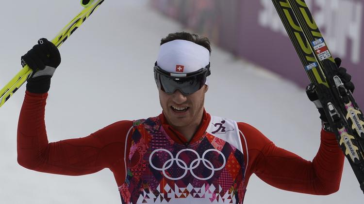 Le skiathlète suisse Dario Cologna célèbre sa victoire à son arrivée sur le complexe Laura de Rosa Khoutor, le 9 février 2014  [ / AFP]
