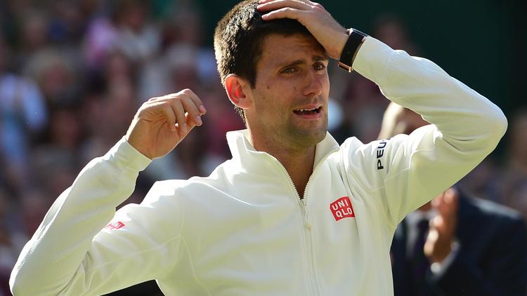 Le Serbe Novak Djokovic ému de sa victoire contre le Suisse Roger Federer en finale du tournoi de Wimbledon, le 6 juillet 2014 à Londres. [Carl Court / AFP]