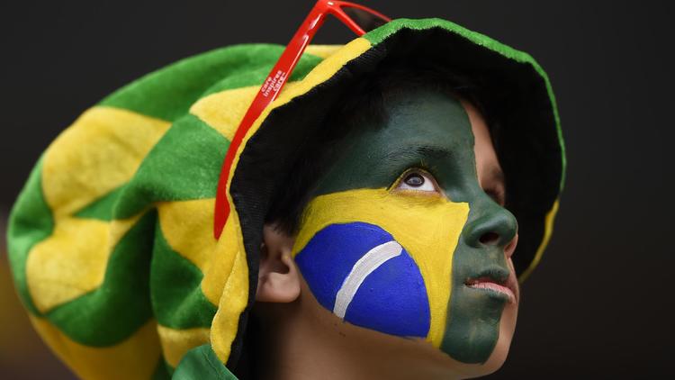 Un jeune supporteur brésilien avant le match pour la 3e place entre le Brésil et les Pays-Bas, le 12 juillet 2014 à Brasilia [Fabrice Coffrini / AFP]