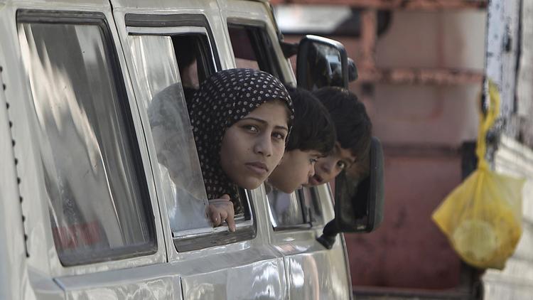 Des familles palestiniennes de retour le 1er août 2014 à Chejaya dans la banlieue de Gaza [Mahmud Hams / AFP]