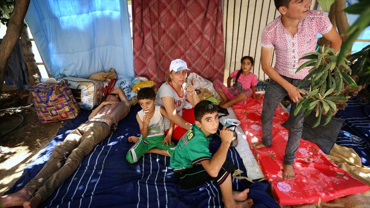 Des chrétiens d'Irak qui ont fui la ville de Qaraqosh ont trouvé refuge à Erbil, capitale de la région autonome du Kurdistan, le 12 août 2014 [Safin Hamed / AFP]