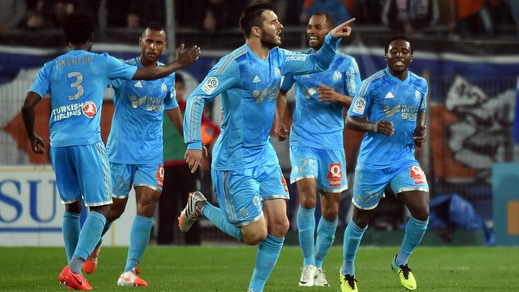 Les joueurs de Marseille exultent après le but d'André-Pierre Gignac (c) contre Montpellier en Ligue 1, le 11 avril 2014 au stade de la Mosson [ / AFP]