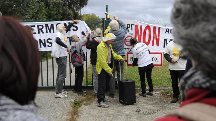 Des manifestants anti-OGM soudent symboliquement la grille d'entrée d'un site de Monsanto à Monbéqui, le 12 octobre 2013 [Pascal Pavani / AFP]