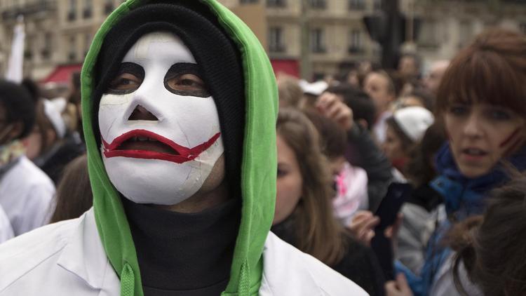 Une sage-femme, masquée, lors d'une manifestation pour le statut des sage-femmes, le 19 février 2014 à Paris [Joel Saget / AFP]